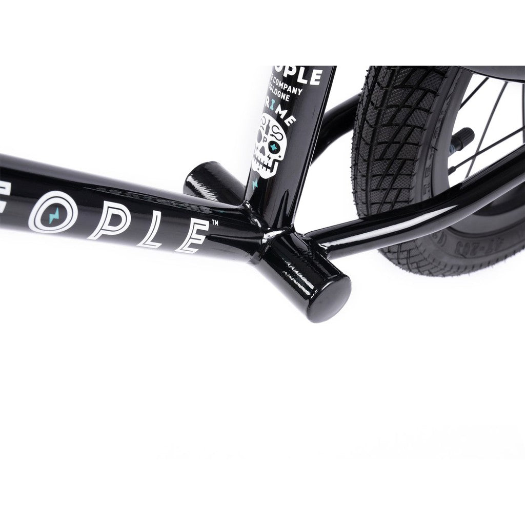 Close-up of a Wethepeople Prime Balance BMX bike frame, showcasing a skull logo. The image focuses on the black frame and rear wheel against a white background, highlighting its craftsmanship.