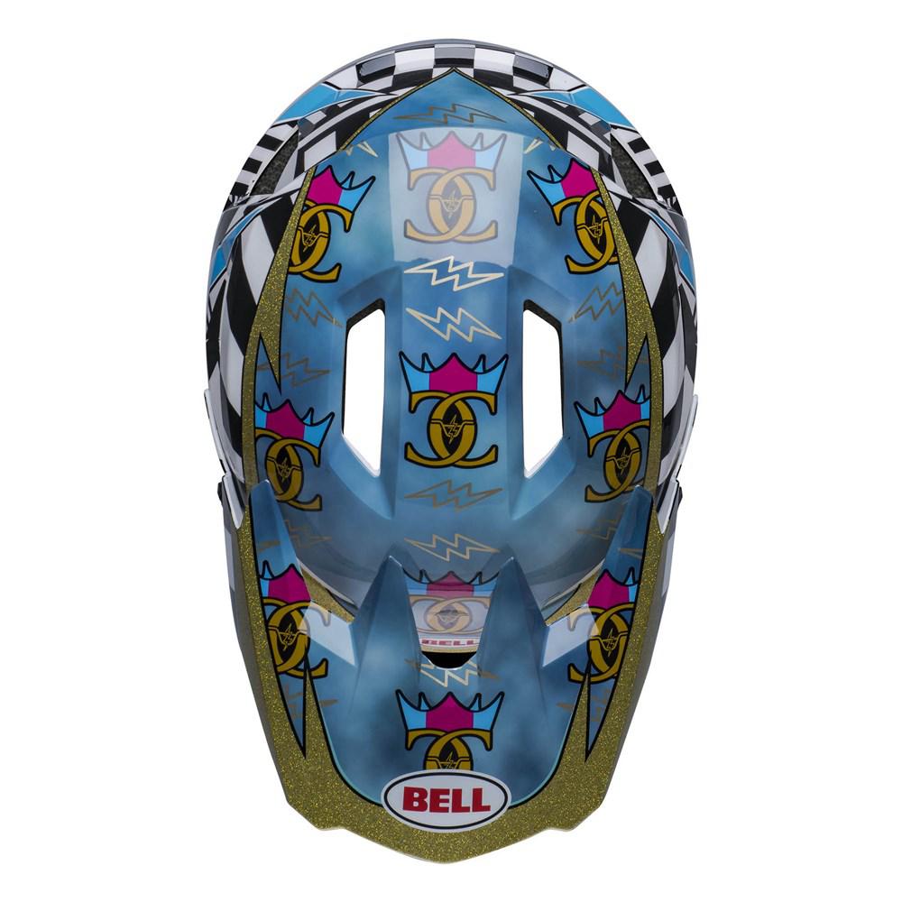 A Bell Sanction 2 DLX MIPS Caiden Black/White helmet with a black and white checkered pattern and various colorful graphic designs, including crowns, swirls, and lightning bolts. This lightweight helmet incorporates MIPS technology for enhanced protection.