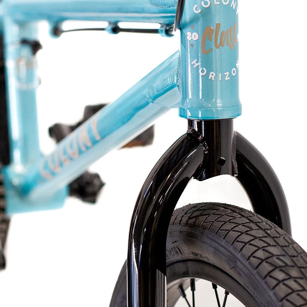 Close-up of a light blue BMX bike frame with the black fork and front wheel visible, featuring a brand logo and "Colony Horizon 20 Inch Freestyle Bike" text on the frame. This bike is perfect for any aspiring Freestyle Olympic athlete.