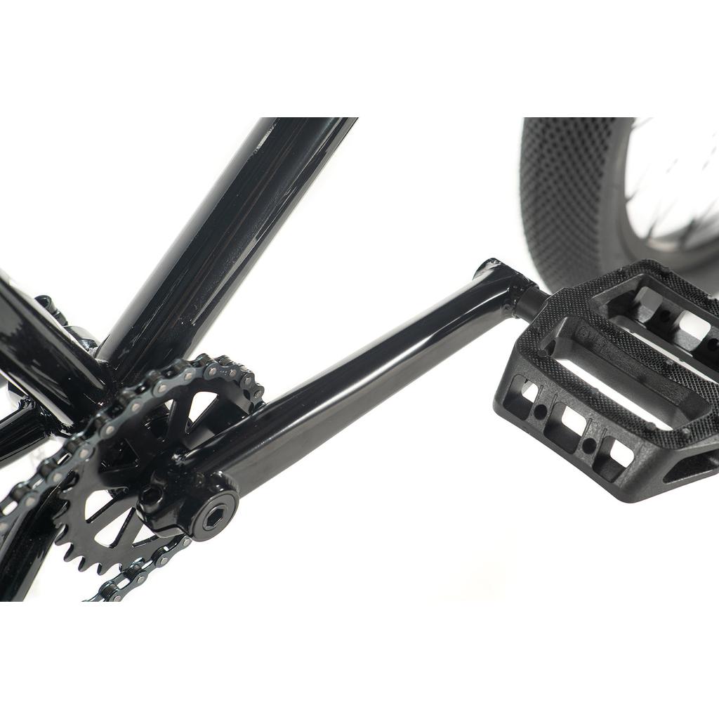 Close-up of the Cult Gateway 20 Inch Bike's black crankset, chainring, and pedal against a white background, highlighting its modern design typical of high-quality bikes.