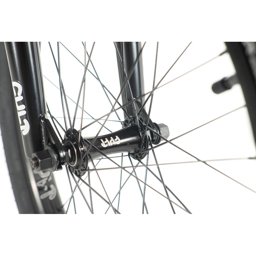 Close-up of a black bicycle hub from the Cult Gateway 20 Inch Bike, highlighting premium quality with silver spokes and bolts against a white background.