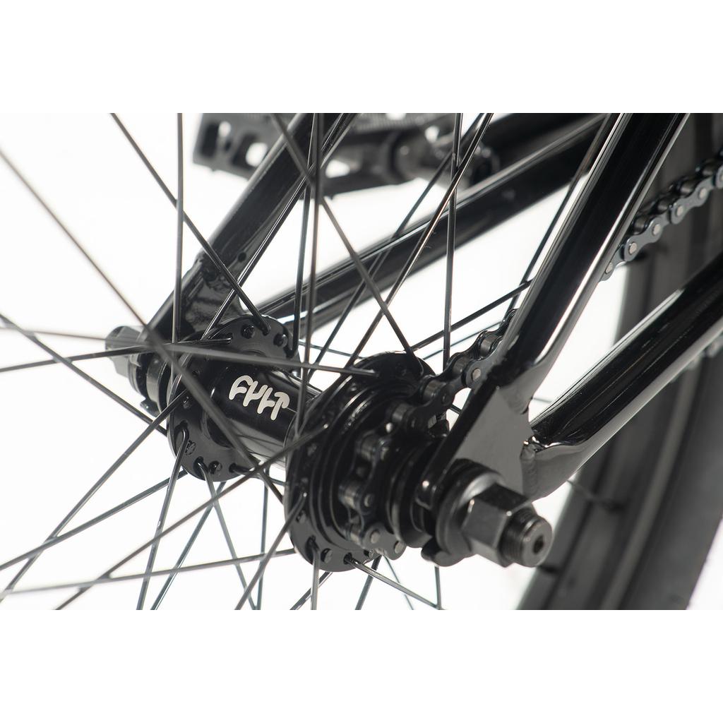 Close-up of a Cult Gateway 20 Inch Bike's rear wheel hub and spokes, highlighting its black metal frame and part of the braking mechanism, embodying modern geometry and premium quality.