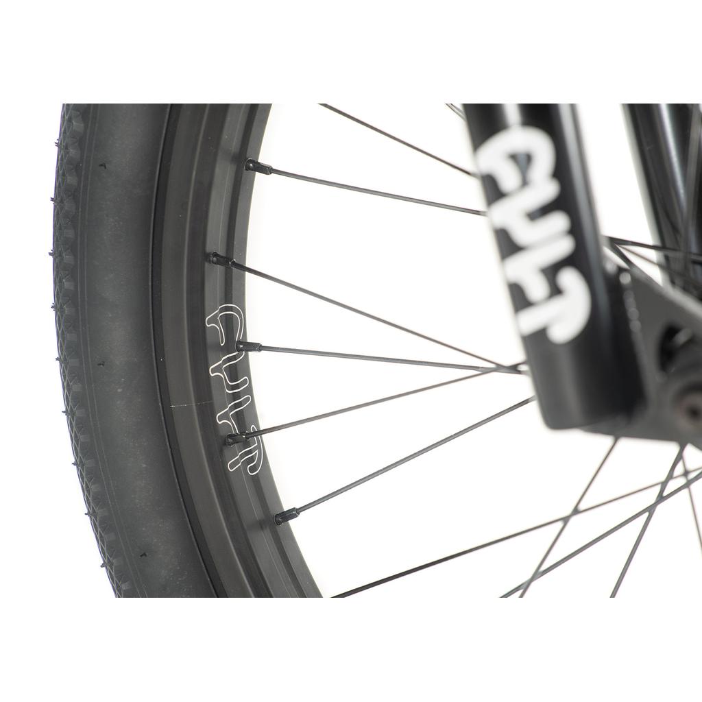 Close-up of a Cult Gateway 20 Inch Bike wheel and tire with black spokes, sleek black rim, and white text on the rim and fork, showcasing modern geometry in premium quality bikes.