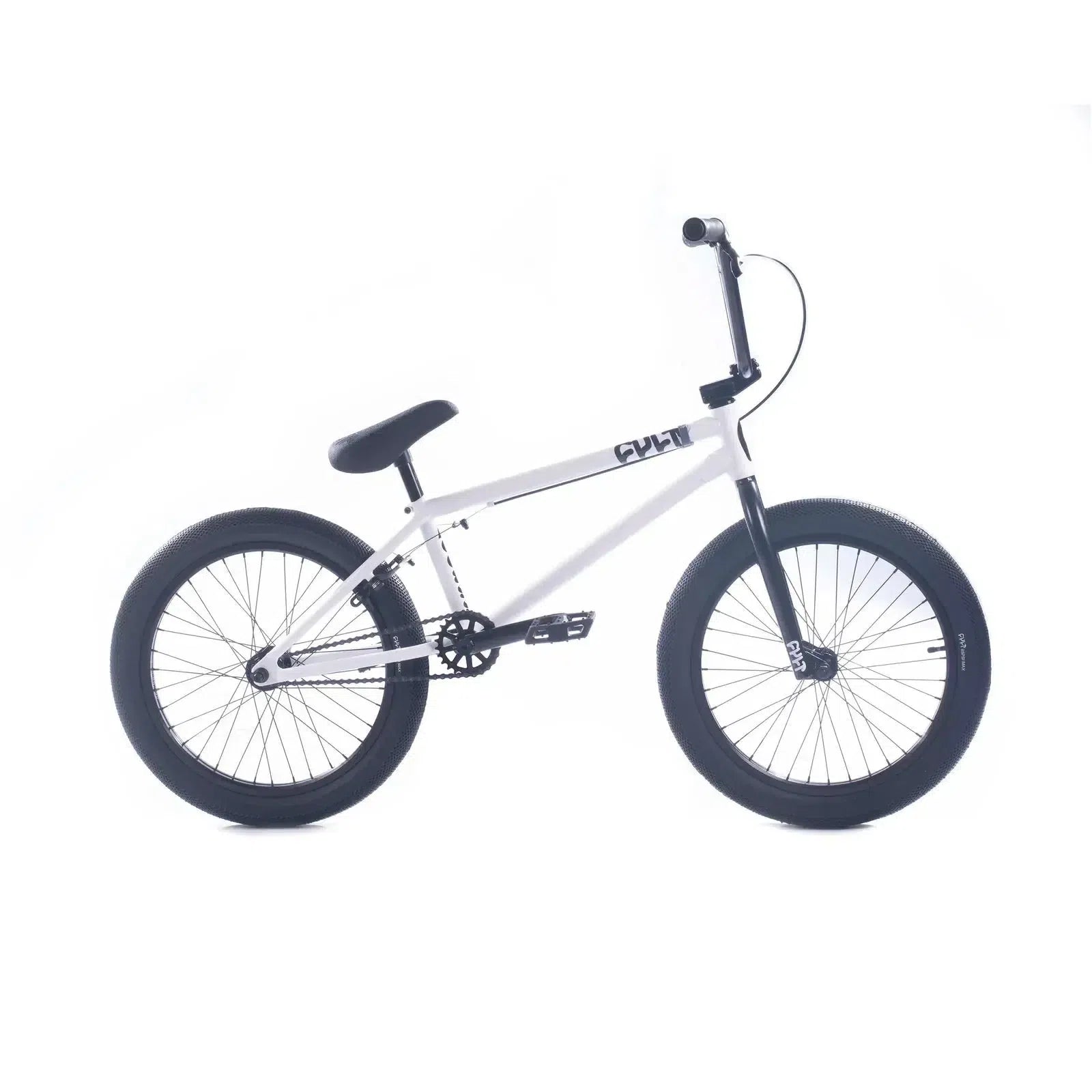 The Cult Access 20 Inch Bike is ideal for beginners, featuring a sleek white BMX design with contrasting black handlebars, seat, and tires. Its durable hi-tensile frame can handle any terrain, all set against a plain white background for a modern look.