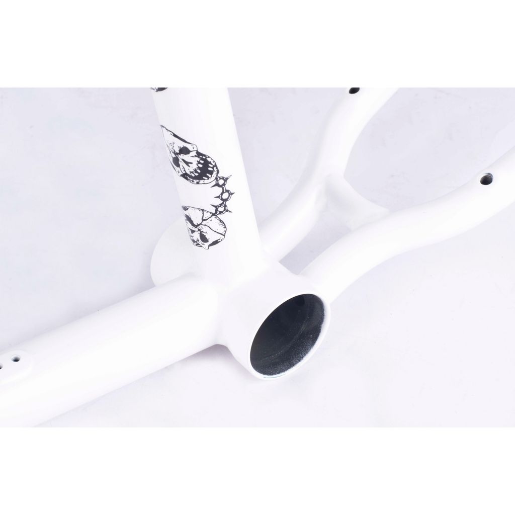 Close-up of the Cult Walsh Frame (Corey Walsh), a white BMX frame featuring black skull designs near the bottom bracket area, set against a white background to highlight its cult classic tubing.