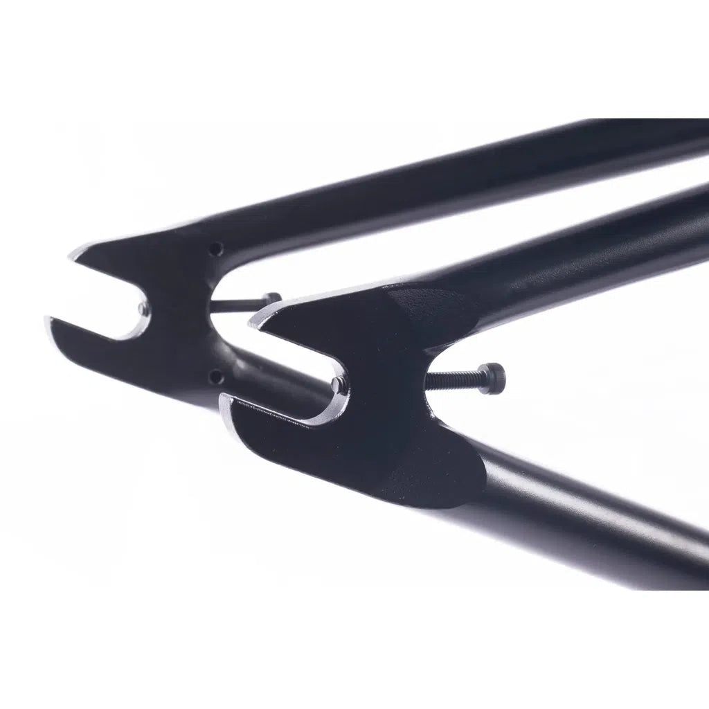 Close-up of two black metal dropouts with a bolt between them, highlighting the strength and precision in the classic tubing of the Cult Walsh Frame (Corey Walsh Signature) BMX.