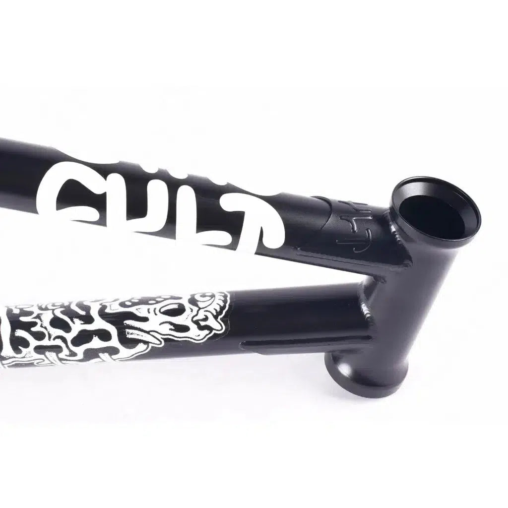 The close-up of the Cult Walsh Frame (Corey Walsh Signature) highlights its striking black design with white "CULT" branding and skeleton graphics, showcasing Corey Walsh's signature style through its classic tubing.