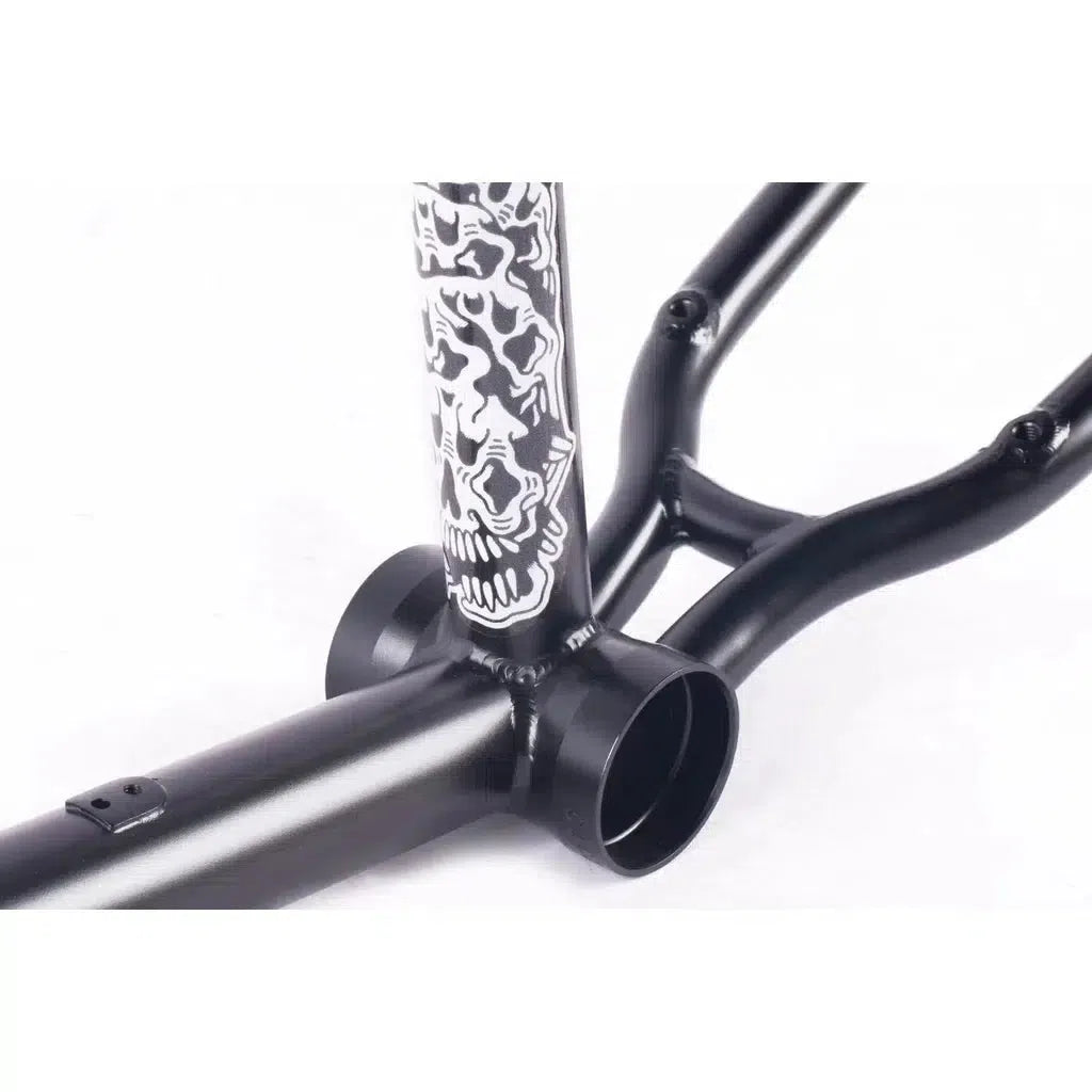 The Cult Walsh Frame (Corey Walsh Signature) in black boasts a white skull design on the tube. Crafted from 100% cult classic tubing, this BMX frame makes a bold statement against its plain white background.