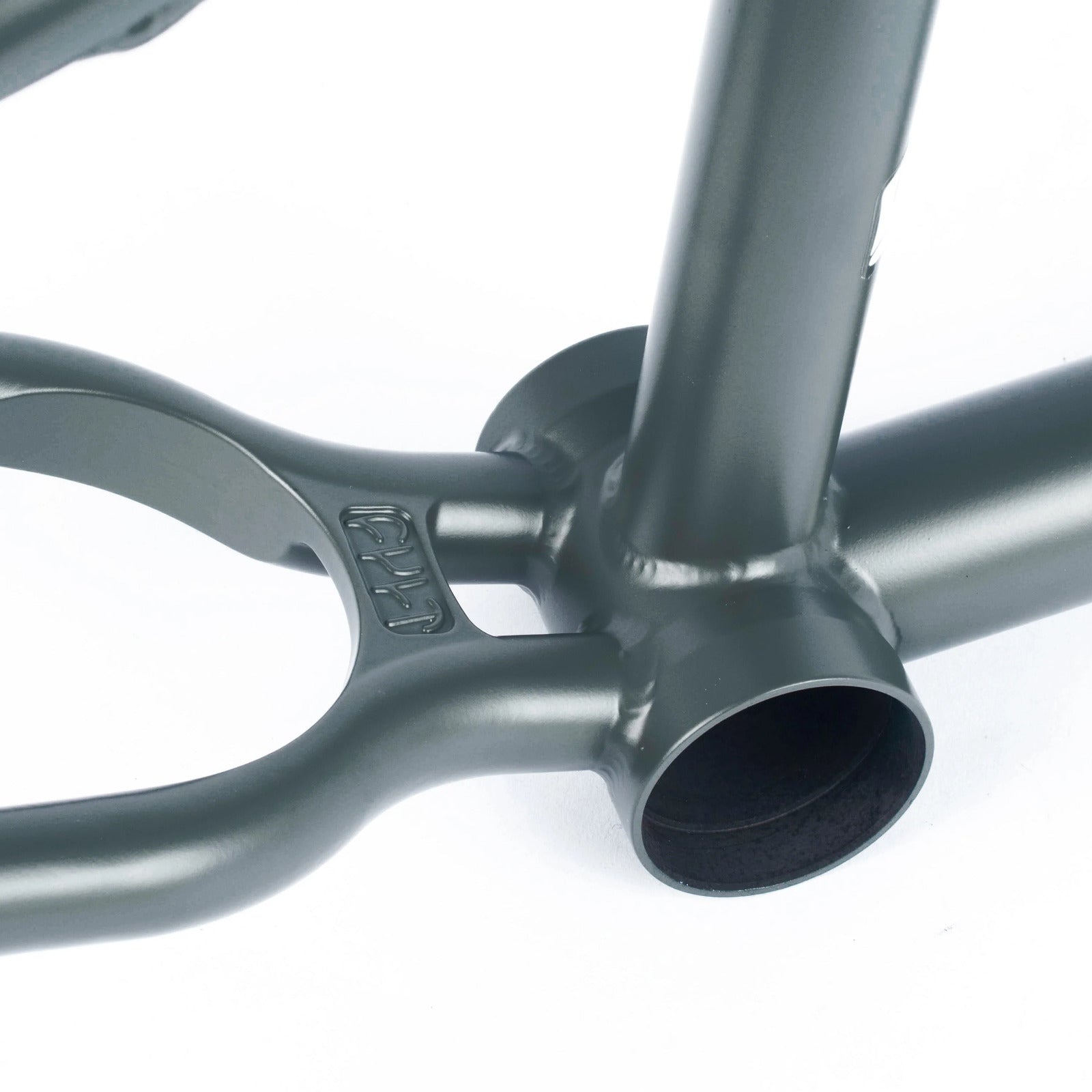 Close-up of the Cult Shorty IC Frame's bottom bracket and chainstay, highlighting a smooth gray finish made from 100% cult classic tubing.