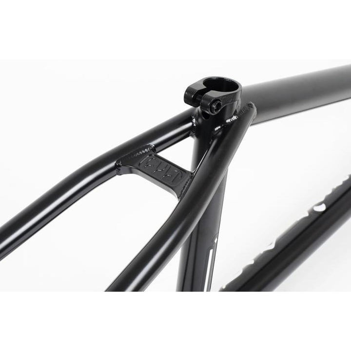 A close-up of the black Cult Heavens Gate Frame reveals a sleek connection between the seat tube and top tube, showcasing an exquisite detail reminiscent of classic Cult tubing with a small reinforcing bridge.