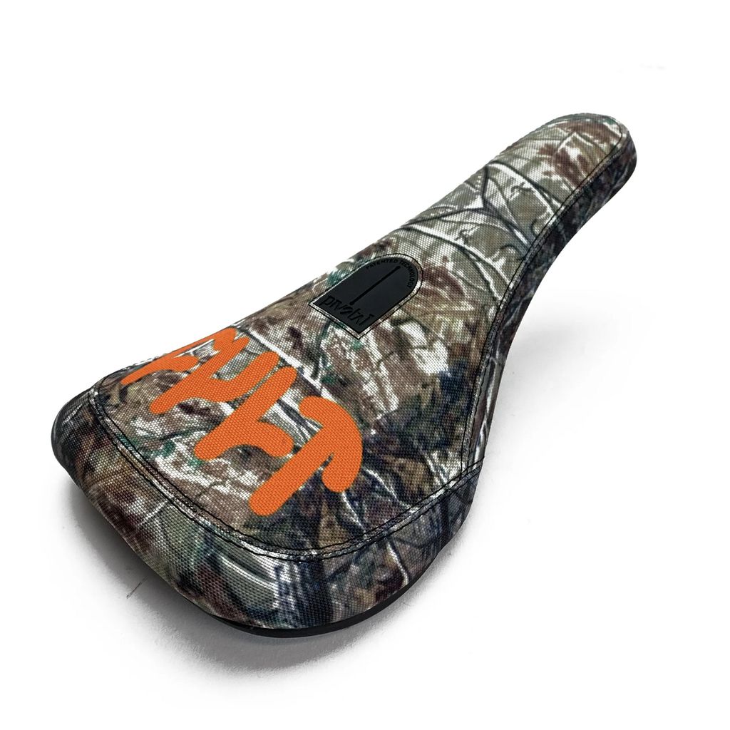 The Cult Tree Camo Slim Pivotal Seat features a robust design with a crisp white backdrop and "cult" in vivid orange on the side, all highlighted by its unique tree camo pattern.