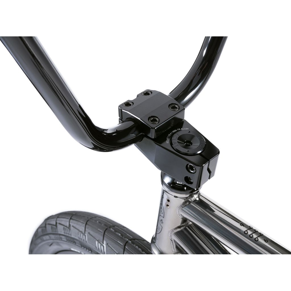 Close-up of a black bicycle handlebar featuring a sleek metal stem and part of the front wheel set against a white background, emphasizing the Wethepeople Envy 20 Inch BMX Bike's chromoly frame.