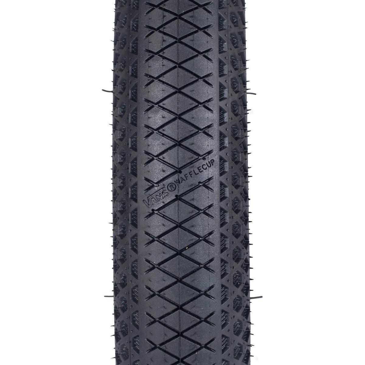 Close-up of a black Cult X Vans Wafflecup 20 Inch Tyre with diamond-patterned tread. "VANS WAFFLECUP" is embossed, showcasing its puncture-resistant Vans rubber design.