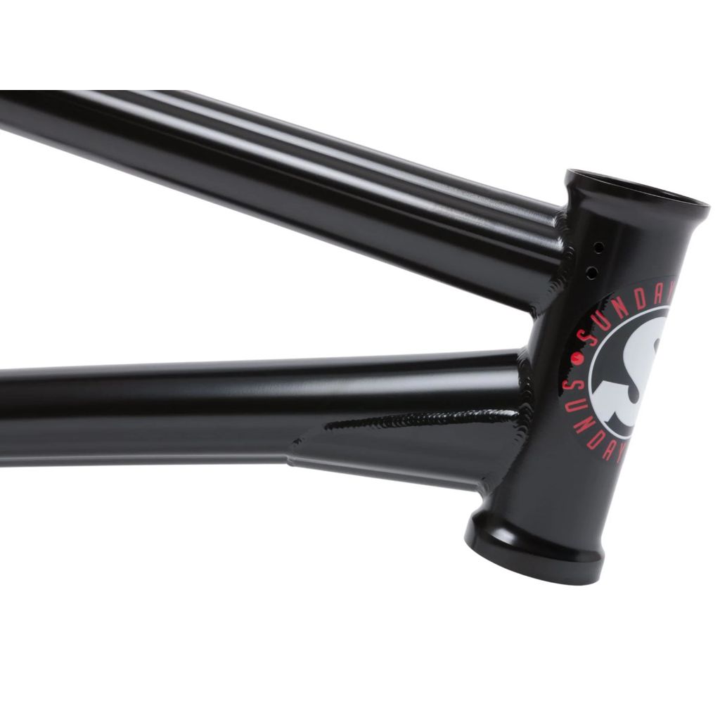 Close-up of the head tube and top tube of a black Sunday Soundwave V3 frame, showcasing the brand's logo on the side. Constructed with 41 Thermal Process, making it both lightweight and durable.