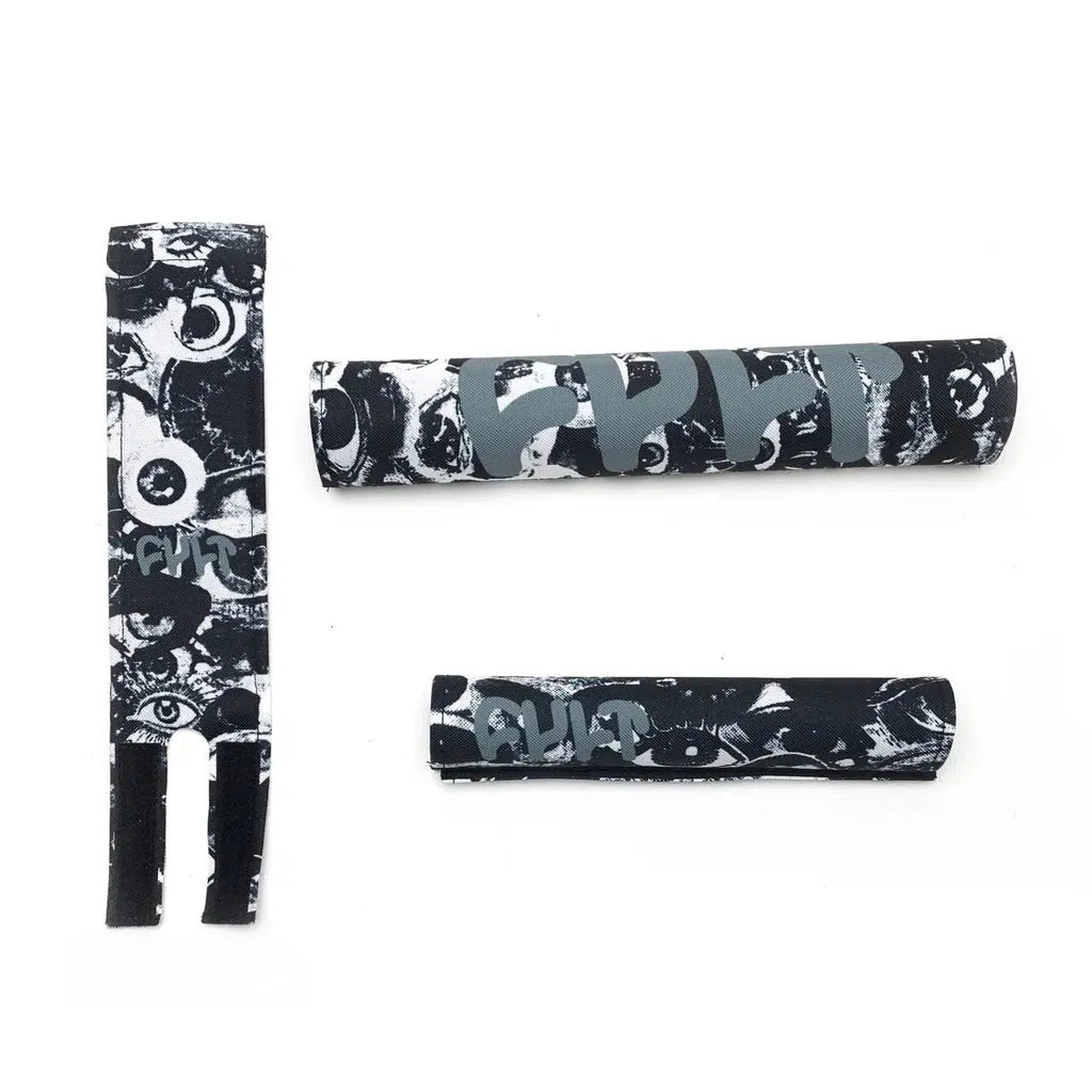 The Cult Pad Set includes three black and white bicycle frame protectors and a matching stem pad, all featuring the word "CULT" in bold letters alongside abstract eye designs.