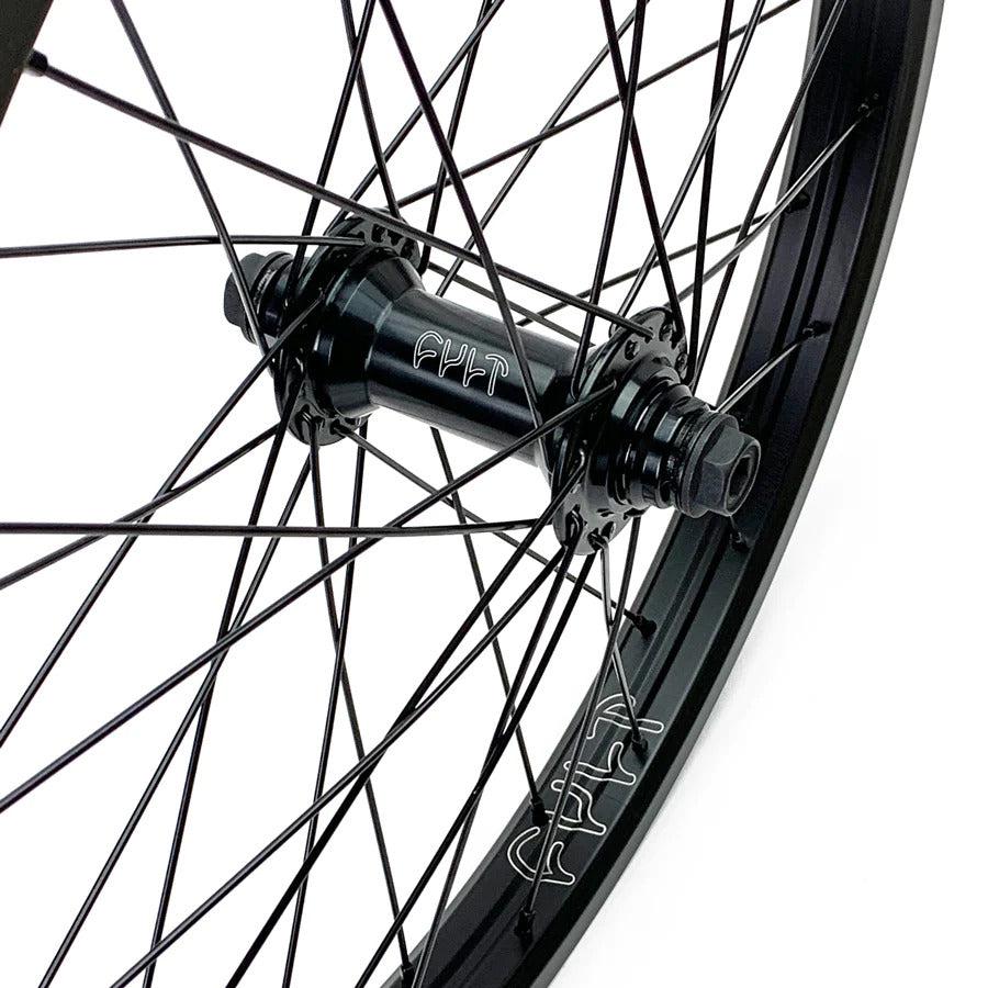 Close-up of a Cult Devotion 20 Inch Front Wheel, highlighting the black spokes and sealed hub, with "FAT" prominently displayed on the durable double-walled rim.