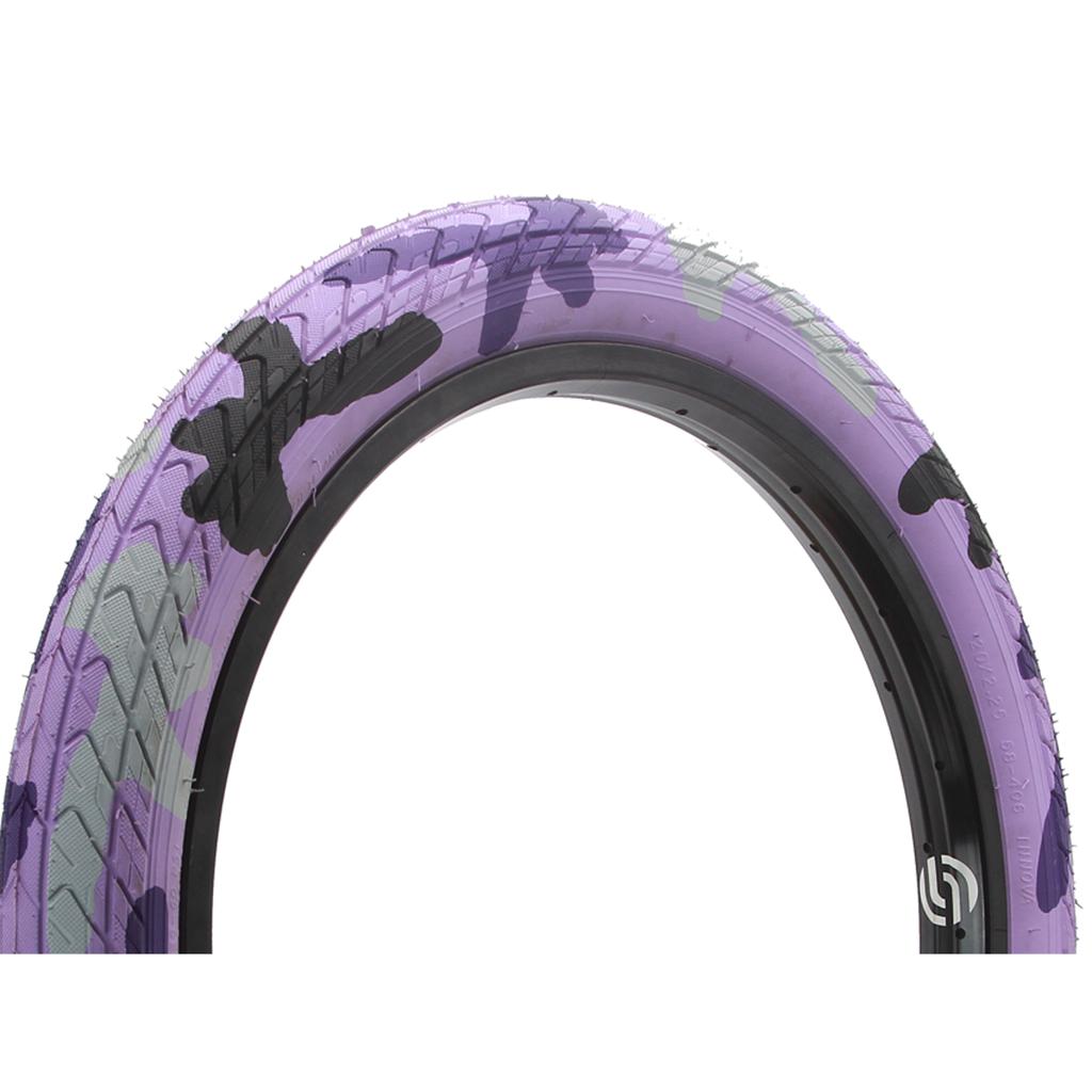 The DRS Arrow FS 20 Inch Tyre features a purple, black, and gray camouflage pattern on a white background.