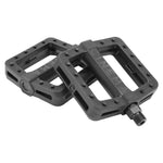 The Cinema Tilt Pedals are designed with two black bicycle pedals that feature textured surfaces, traction pins, and visible screws to ensure superior grip and durability.