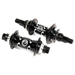 Two black Profile Limited Edition Cats Eye bicycle hubs with white logos, featuring multiple holes for spokes and hexagonal end caps.