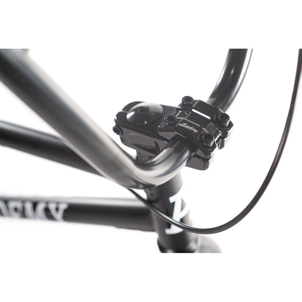 Close-up of the handlebar from the Academy Aspire 20 Inch Bike, showcasing CrMo bars with a robust clamp and the brand logo in clear view.