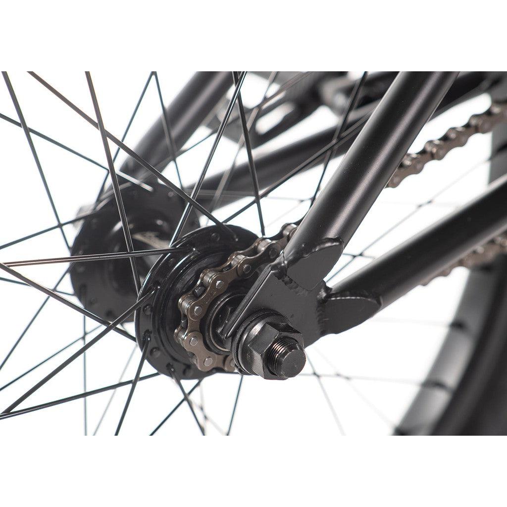 Close-up of the Academy Aspire 20 Inch Bike's rear wheel highlighting its black metal spokes, sealed hubs, chain, and gears.