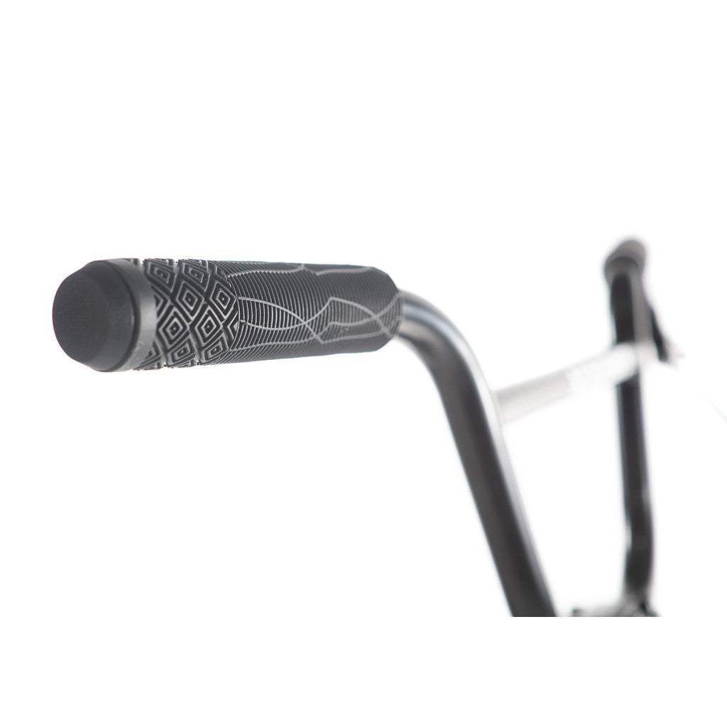 Close-up of the Academy Inspire 16 Inch Bike's handlebar with a patterned grip on a white background, highlighting its sleek design and attention to detail.