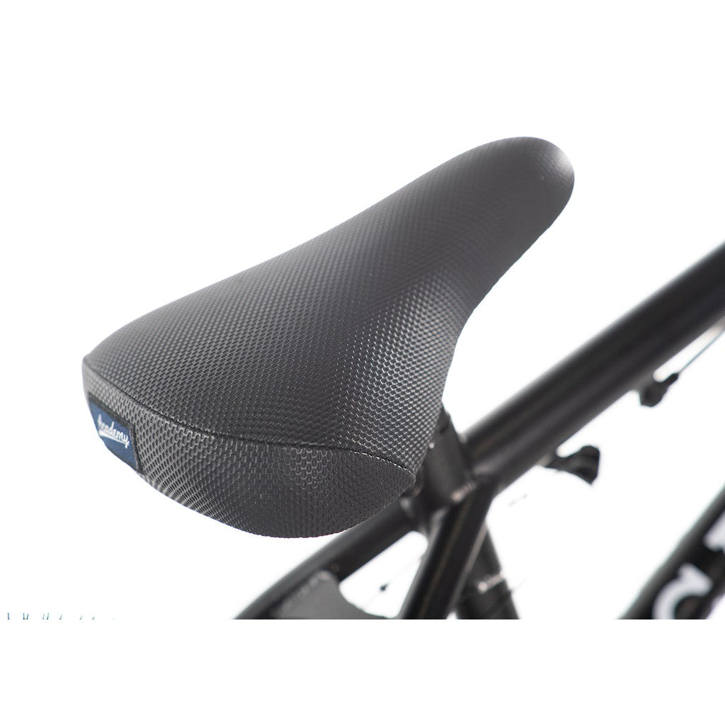 Close-up of a textured black bicycle seat mounted on an Academy Inspire 16 Inch Bike frame, perfect for BMX bikes with double wall rims.