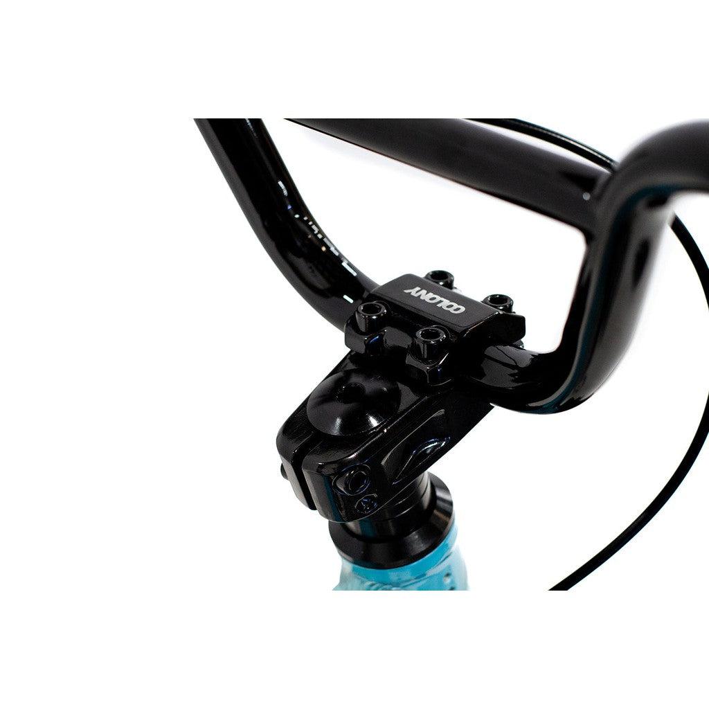 Close-up of a black BMX handlebar attached to the stem of the Colony Horizon 12 Inch Bike, with the brand name "COLONY" visible on top of the stem, highlighting its lightweight alloy frame.