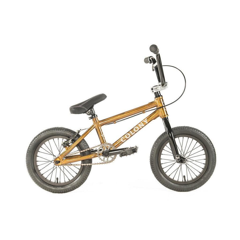 The Colony Horizon 14 Inch Bike features a lightweight alloy metallic gold frame, complemented by a black seat and black handlebars, making it the perfect choice for aspiring BMX Freestyle Olympic athletes.