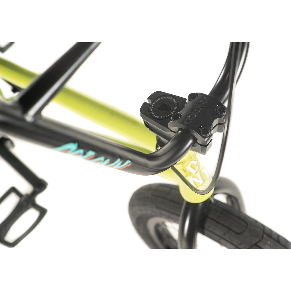 Close-up of a limited edition BMX bike handlebar and stem featuring the Colony BMX logo. The frame and front tire of the Colony Rico Pro 20 Inch Bike are visible against a pristine white background.