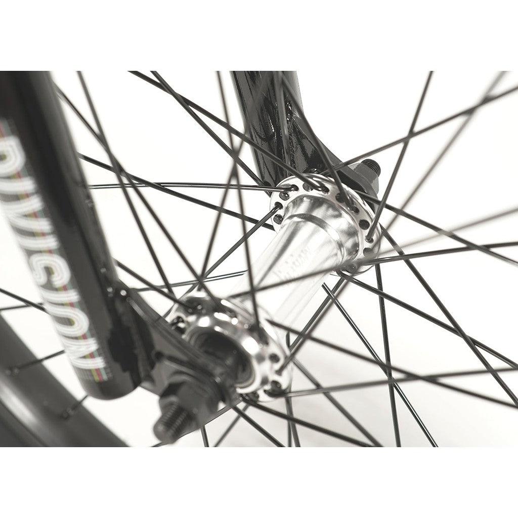 Close-up of the Division Fortiz 20 Inch Bike's front wheel hub and spokes, highlighting part of the black fork with the word "Division" on it.