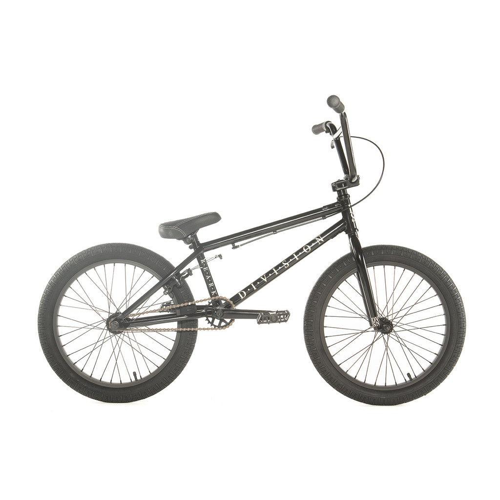 The Division Reark 20 Inch Bike showcases a sleek black BMX design with a sturdy hi-tensile steel frame, straight handlebars, and thick tires, promising an exhilarating ride.