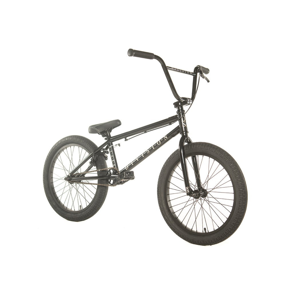 Introducing the Division Reark 20 Inch Bike—a stylish black BMX crafted from Hi-Tensile steel, featuring 3-piece cranks, large wheels, a straight handlebar, and a padded seat—all elegantly displayed from the side against a pristine white background.