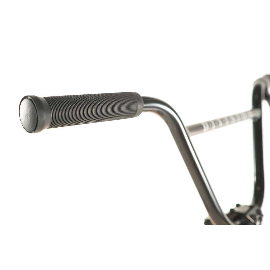 Close-up of the handlebar grip on a Division Reark 20 Inch Bike, featuring a textured surface and slightly bent bar, set against a white background to highlight the durable hi-tensile steel construction.