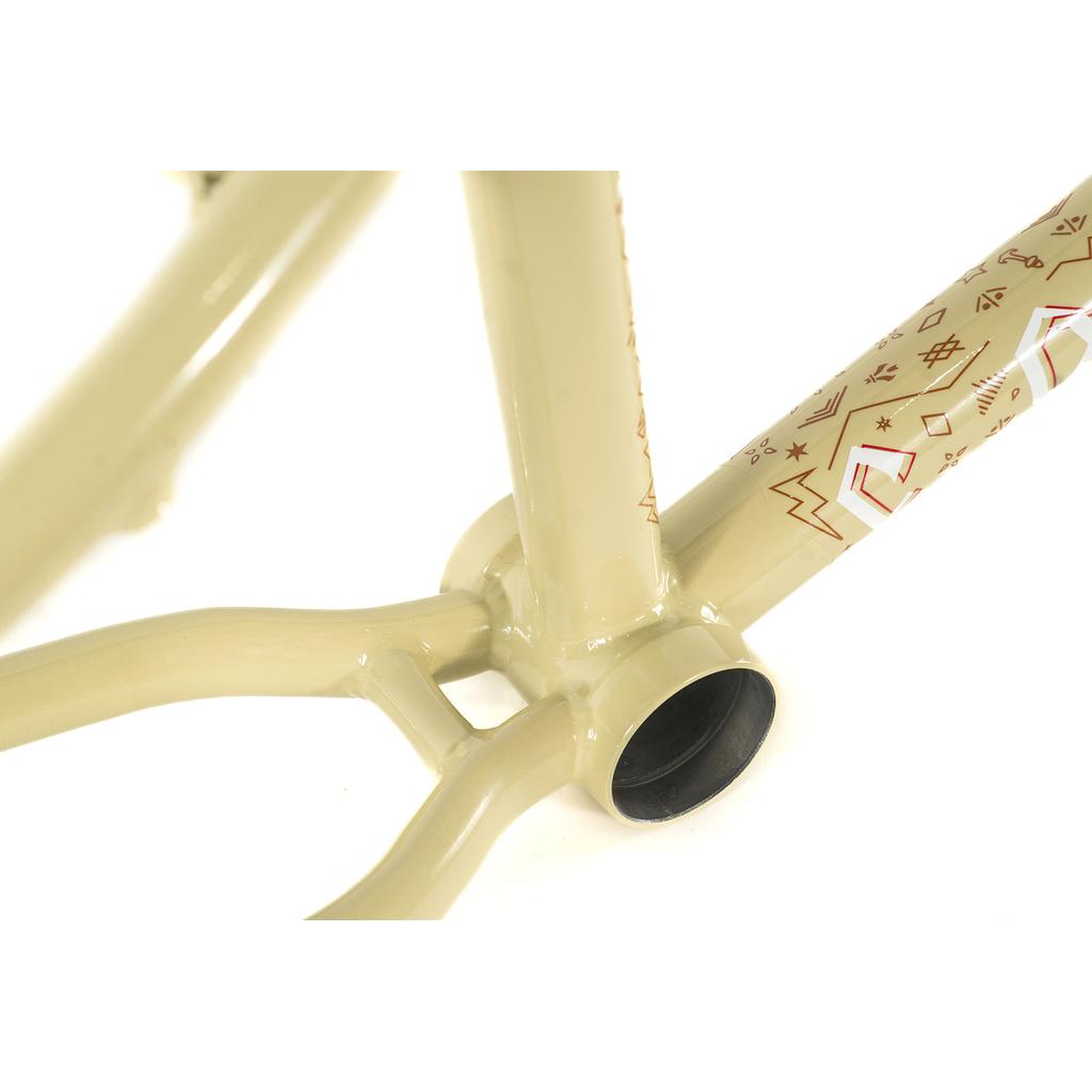 Close-up of a Colony Rico 'Lite' Frame's beige bottom bracket area, featuring decorative red patterns on the tubing.