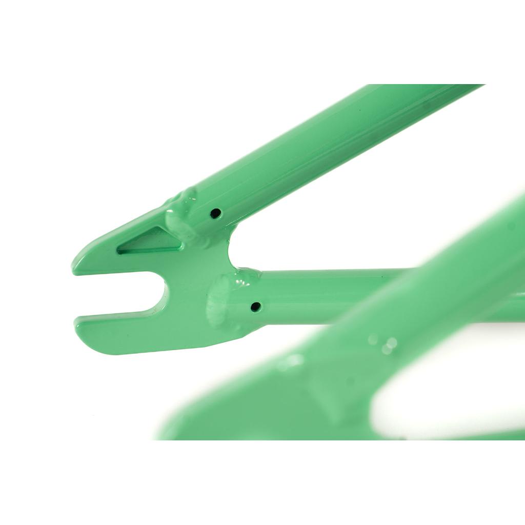 Close-up of two green metal dropouts from the Colony Rico 'Lite' Frame, showcasing their smooth finish and attachment points.