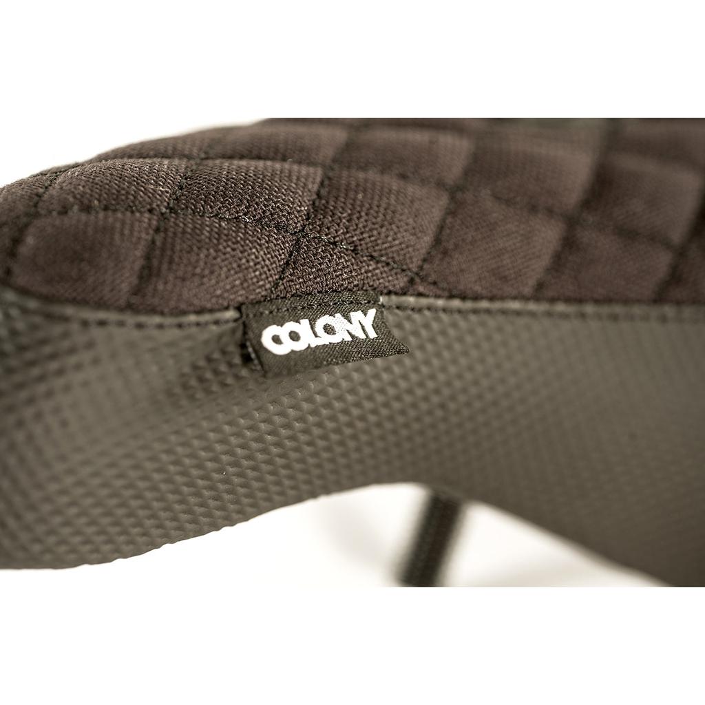 Close-up of the black Colony Wallwork Pivotal Seat with quilted fabric texture, textured sole, and diamond stitching, offering an elegant touch reminiscent of Jake Wallwork designs.