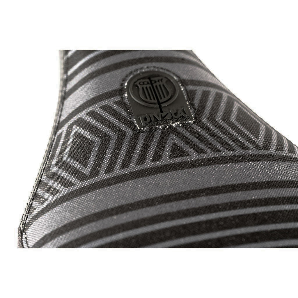 Close-up of the Colony Paterico Pivotal Seat, featuring a gray and black geometric pattern with a logo emblem near the top, showcasing its signature pivotal seat technology.