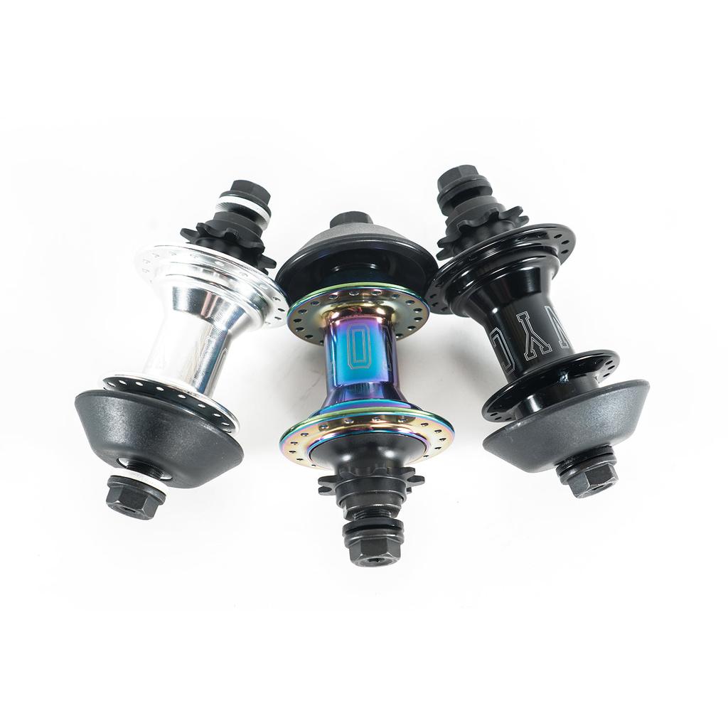 Three bicycle hubs in silver, iridescent, and black are side by side, displaying various bolt and spoke setups. Notably, the Colony Wasp Rear Hub stands out as a top choice cassette hub for BMX enthusiasts seeking premium performance.