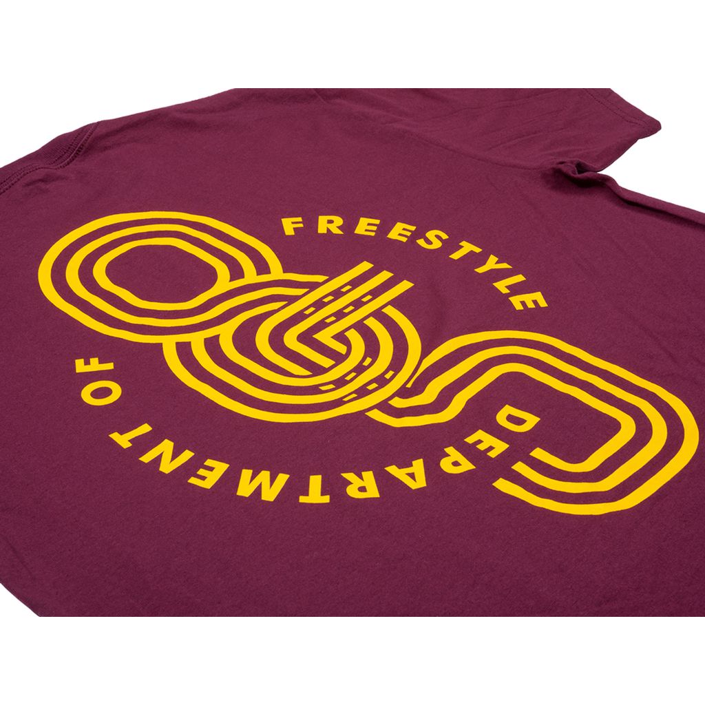 The Odyssey Athens T-Shirt is a maroon top with a yellow graphic design displaying the text "DEPARTMENT OF FREESTYLE" in a circular pattern.