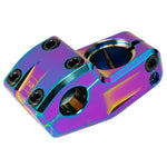 The Wethepeople Kira (Keiryo Kudo) Top Load Stem features a vibrant rainbow finish with multiple bolt holes and uses shark tooth clamping for secure handlebar attachment.