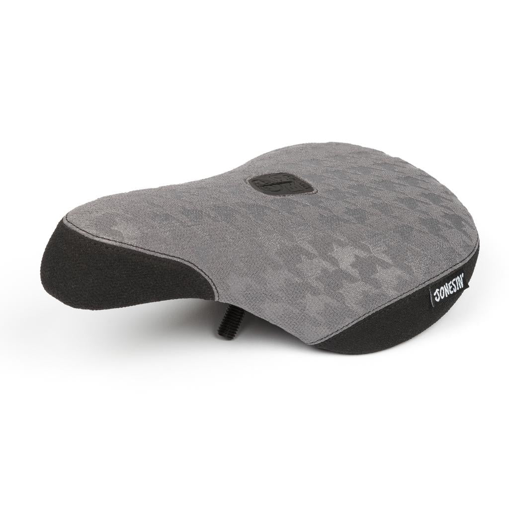 The BSD Jonesin Pivotal Seat is a gray, textured bike seat with black trim, prominently featuring "ODYSSEY" on the side and equipped with durable Kevlar bumpers for protection.