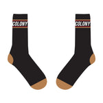 The Colony BMX Logo Socks feature a black color scheme with brown toes and heels, highlighted with the word "COLONY" and a red stripe near the top. Proudly part of the Logo Socks collection, these socks are Australian Made and ideal for any Colony BMX enthusiast.