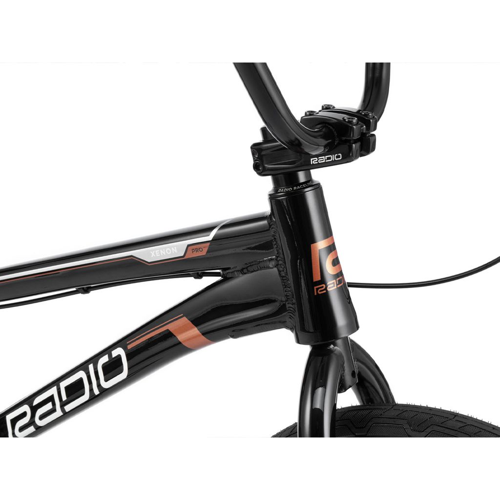 Close-up image of a black Radio Xenon Pro Bike frame, focusing on the handlebars, front tire, and part of this sleek race bike.