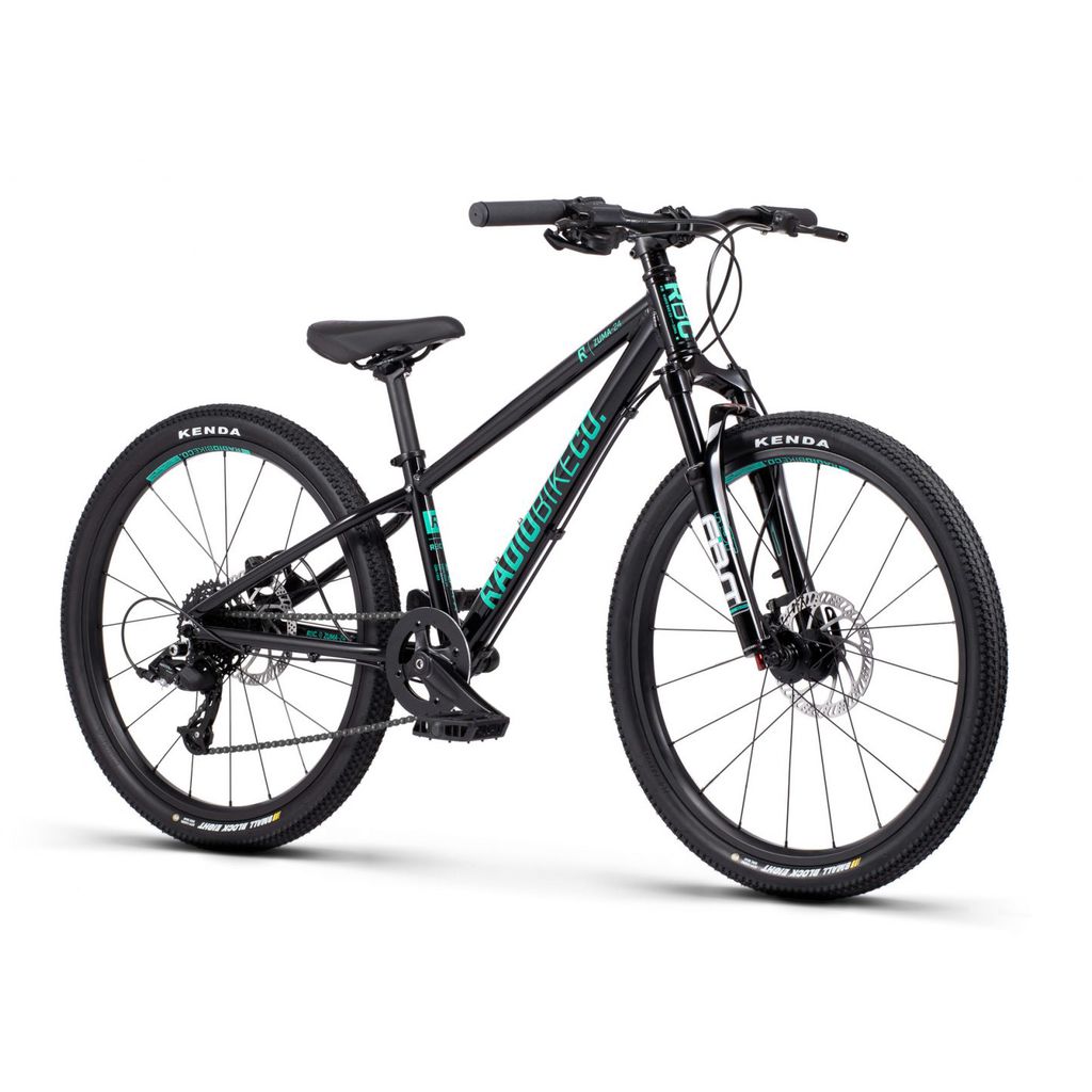 The Radio 24 Inch Zuma Sus Bike is a black mountain bike with teal accents, featuring a lightweight alloy frame, front suspension fork, disc brakes, and Kenda tires. It is perfectly designed as a kid-sized MTB bike.