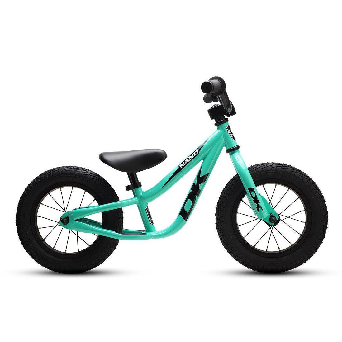 The DK Nano Balance Bike is beautifully presented from a side perspective, boasting an eye-catching turquoise frame complemented by sleek black wheels, handlebars, and seat. It's an ideal choice for young riders making the transition to beginner BMX bikes.