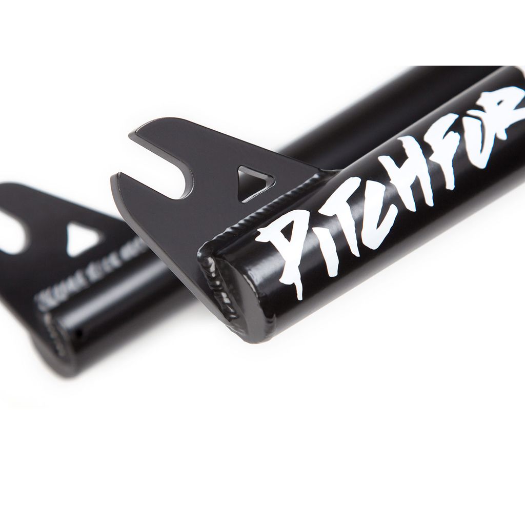 Close-up of the black fork dropout of the S&M Pitchfork XLT 18 Inch, laser cut from 4130 CrMo steel, featuring bold white "PITCHFORK" text in a stylized font.