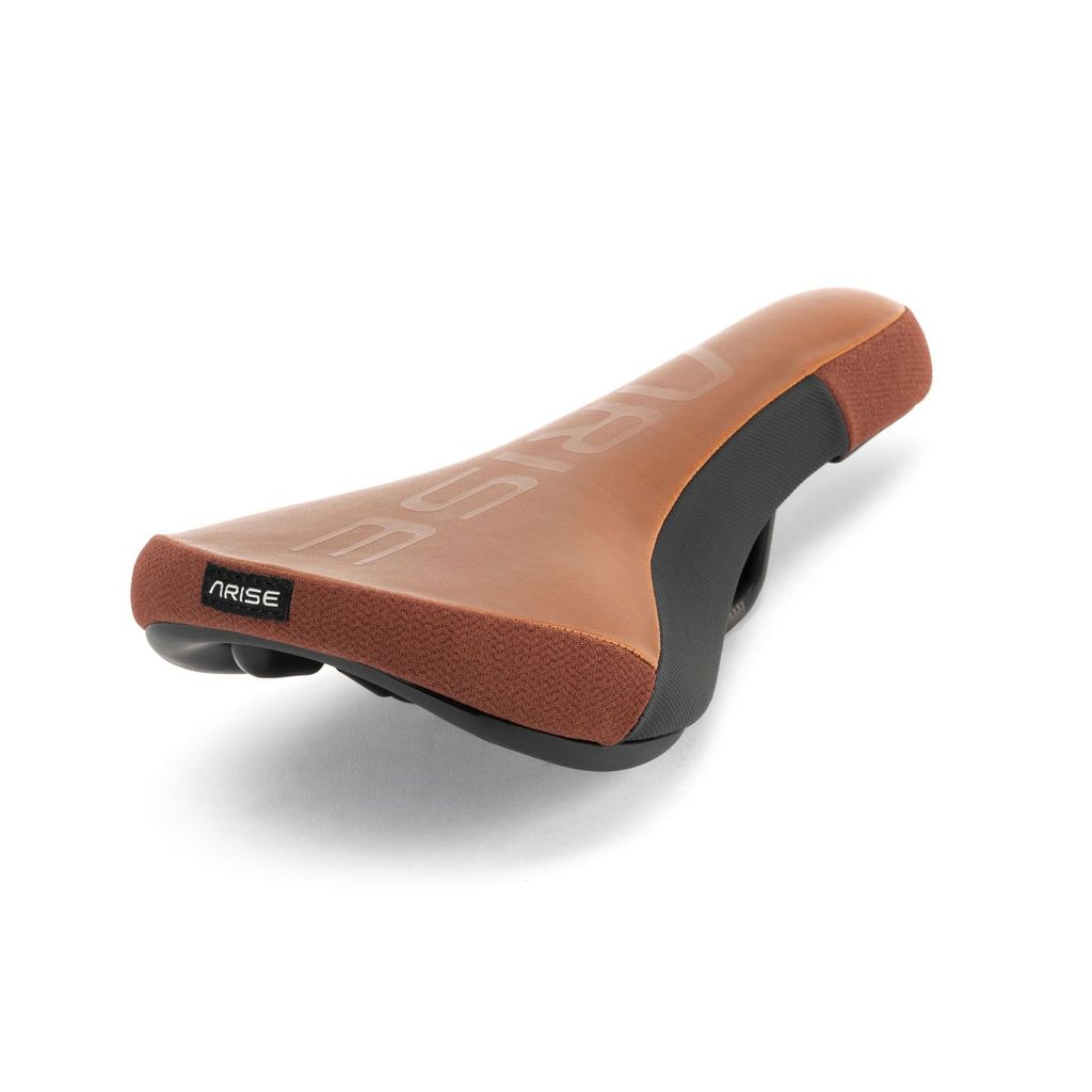 A brown and black Arise Sensor Railed Seat, featuring a grippy silicon top print, is perfect for downhill riding and shown from an angle.