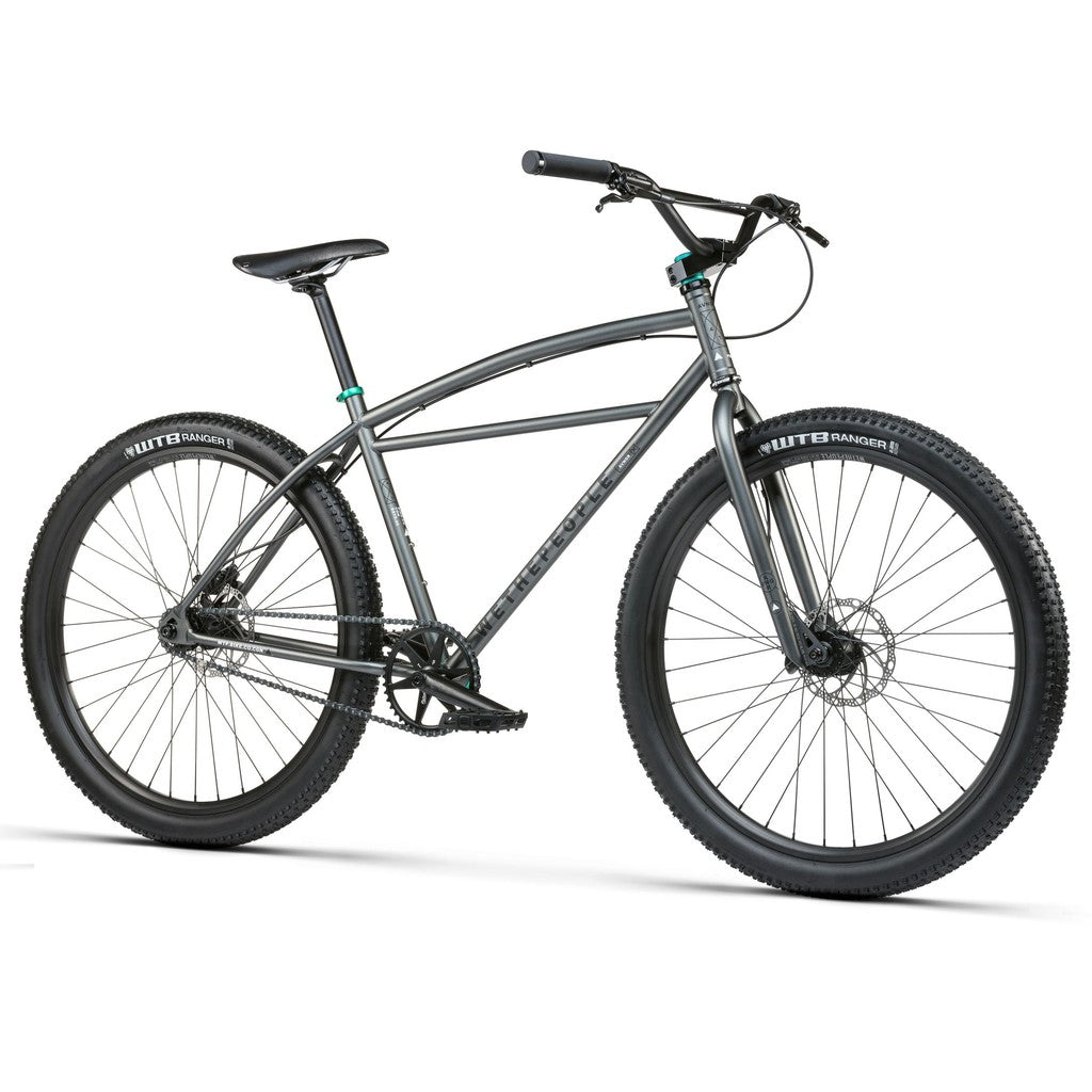 Presenting the Wethepeople Avenger 27.5 Inch Bike with a durable gray frame, wide wheels, and reliable front and rear disc brakes for excellent control and performance across all terrains.