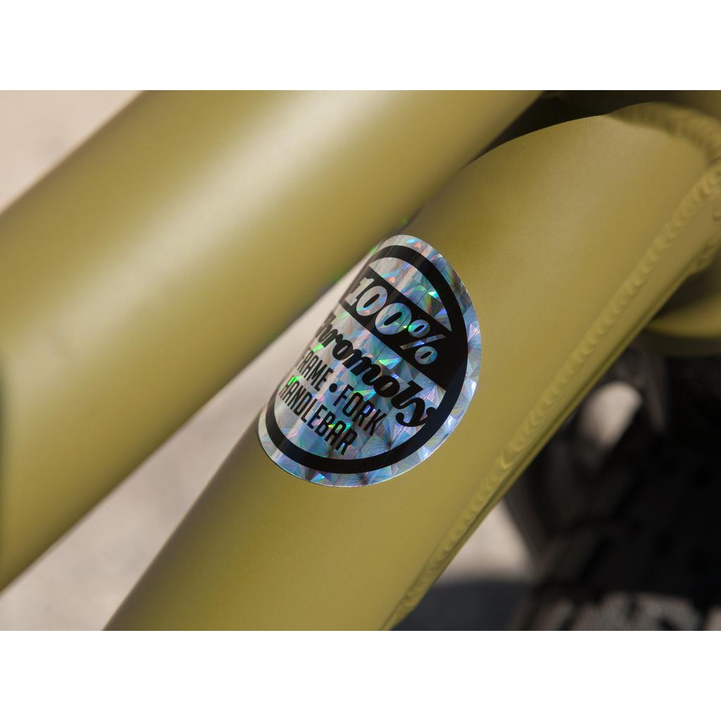 Close-up of an olive green bicycle frame labeled "100% Chromoly Fork - Invisiblebra," capturing the sleek craftsmanship of the Sunday Wave Length 20 Inch bike, reminiscent of something Gary Young might ride.